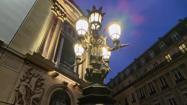 Close-up view from the Palais Garnier Parisian streetlamp at night, Paris, France.