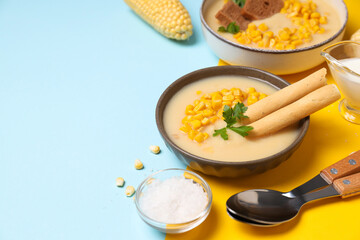 Corn soup in a plate, on a blue background.