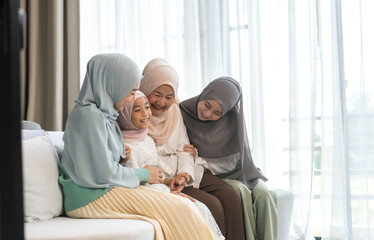 Four generations of muslim woman in hijab enjoying family time showing love, joy and happiness, grandmother, mother, daughters and granddaughter celebrating family traditions, togetherness and support