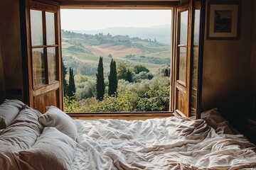 Ein Bett vor einem Fenster mit Blick auf die Landschaft der Toskana 