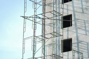 Extensive scaffolding providing platforms for work in progress on a new apartment block,Tall...