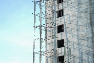 Extensive scaffolding providing platforms for work in progress on a new apartment block,Tall...