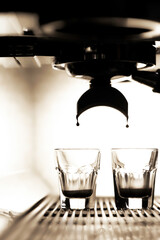Coffee brewing by espresso machine. Glass of  espresso.