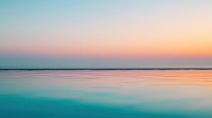 Serene ocean view during sunset with soft pastel sky colors and calm water.