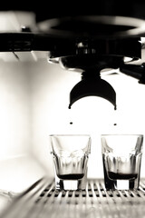 Coffee brewing by espresso machine. Glass of  espresso.