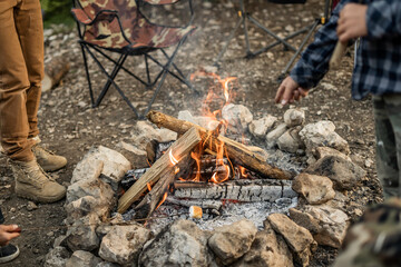 Campfire scene with people roasting marshmallows outdoors