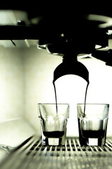 Coffee brewing by espresso machine. Glass of  espresso.