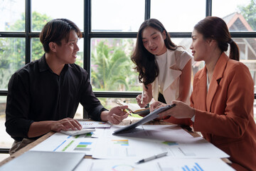 Teamwork process Team of business men and women use calculators to calculate numbers, business statistics, profits, cost analysis, graph documents, growth rates. Data chart on the desk.