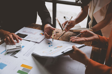 Teamwork process Team of business men and women use calculators to calculate numbers, business...