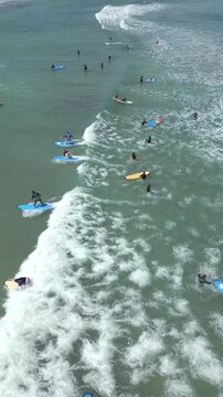 Aerial view of people taking surfing lessons in the ocean, Bali, Indonesia