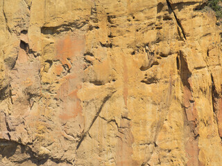 A rocky cliff with a brownish color