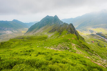 Hiking in Fagaras mountains on Iezerul Caprei peak over Transfagarasan serpentine road carpathian mountains. Mountains landscape