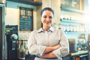 Fototapeta premium Crossed arms, happy and portrait of barista in restaurant with confidence for food industry. Job, pride and woman waitress from Canada with smile for hospitality career in cafe with serving service