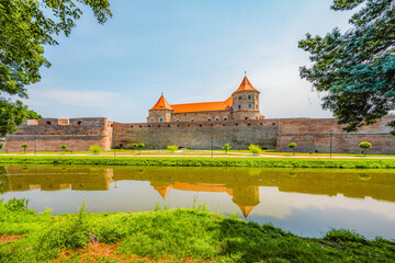 Naklejka premium Fagaras Citadel Fortress and the Cathedral near Fagaras mountains in Fagaras city in Romania