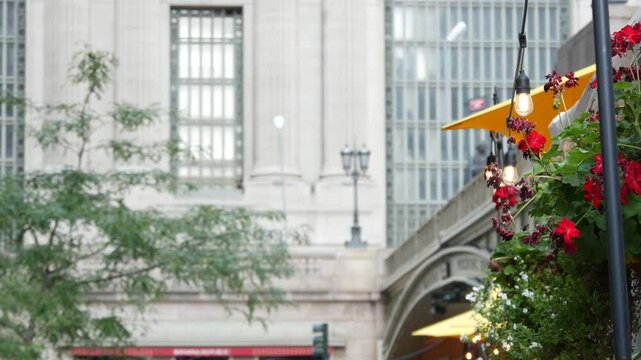 New York City Grand Central Terminal railway station, 42 street. Manhattan Midtown. Bridge on Pershing Square, NYC, USA. American urban scene, United States. Light bulb garland, umbrellas and flowers.