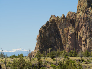 A mountain range with a snow covered peak in the distance