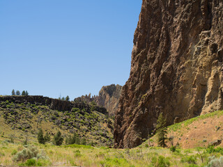 A mountain range with a clear blue sky in the background