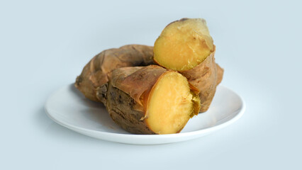 Baked sweet potato on white background.