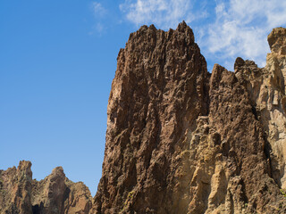 A rocky mountain with a clear blue sky in the background