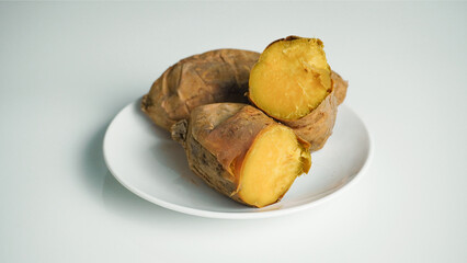 Baked sweet potato on white background.