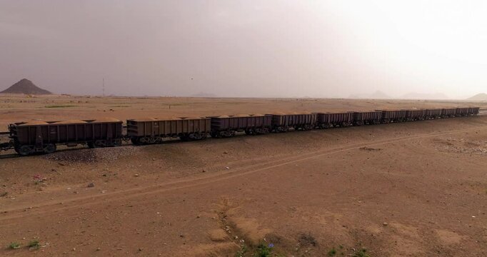 Iron Ore Train Travel Across The Sahara Desert Parked In Choum, Mauritania. - aerial shot