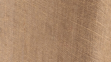 Sackcloth or burlap texture. Hessian sackcloth burlap woven texture background, Cotton woven fabric close up with flecks of varying colors of beige and brown, with copy space for text decoration.