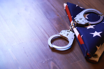 Handcuffs on American Flag Symbolizing Law Enforcement and Justice System in USA