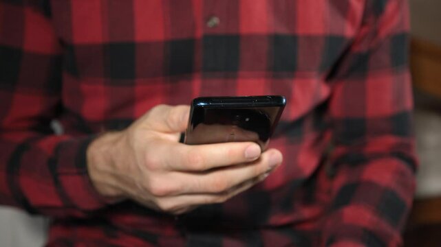 Junger Mann nutzt Smartphone und scrollt