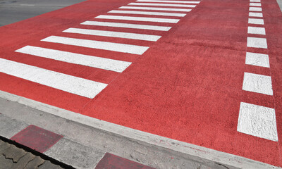 colourful zebra crossing, red and white painted pedestrian zebra crosswalk