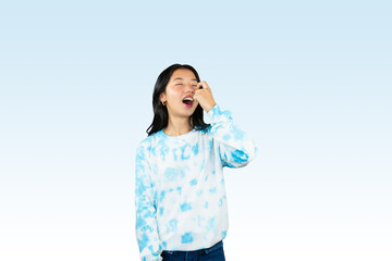 Yougn Asian girl with blue dress points and gives various expression and gestures isolated happy sad