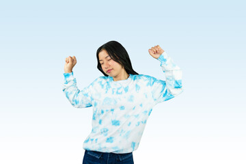 Obraz premium Yougn Asian girl with blue dress points and gives various expression and gestures isolated happy sad