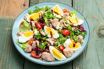 Canned Tuna salad with eggs and tomatoes photography . Top view