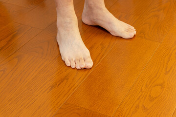 木の床の上に裸足で立つ