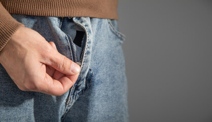  Man zipping up denim jeans.