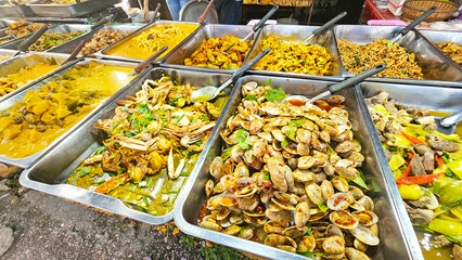 Thai Street Food Feast: A vibrant array of enticing Thai dishes, bursting with color and flavor, beckon hungry passersby at a bustling street food market.