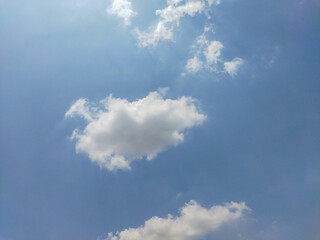clouds in a clear sky with high sunlight
