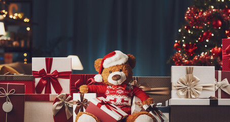 Many Christmas gifts and cute teddy bear