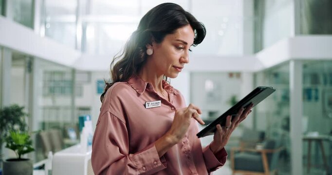 Serious, typing and woman with tablet, healthcare and scheduling of appointment, receptionist or online. Digital, reading and person with information on app, administration or medical coder in clinic