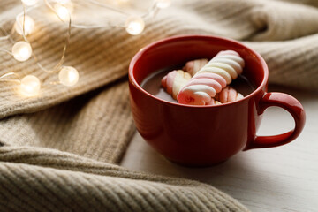 Cup of delicious hot chocolate on wooden table background.