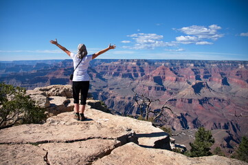 Rear view of mature woman standing on the rim of Grand Canyon