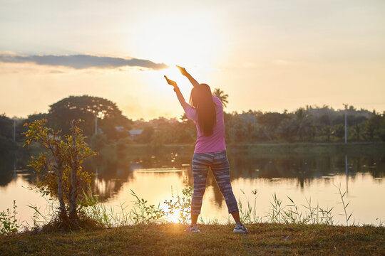 Asian woman exercising during sunset