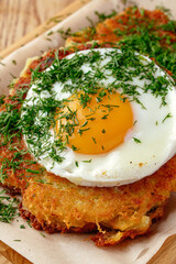 potato pancakes with fried egg and herbs