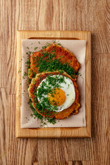potato pancakes with fried egg and herbs