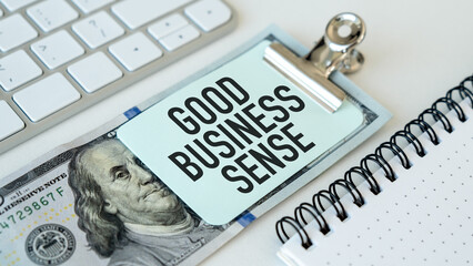 A clip holding a piece of paper that says Good Business Sense on it