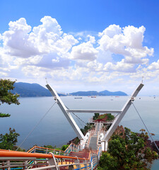 Songdo Yonggung Suspension Bridge and seascape, Busan, South Korea. Beatiful sea landscape with a bridge to a rocky island, Amnam Park, Busan, Republic of Korea