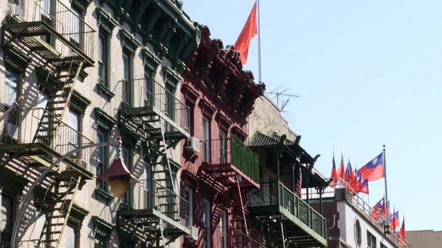 New York City, United States. Manhattan Chinatown Mott street, chinese ethnic district buildings architecture, USA. American red brick house in little China. Fire escape ladder in NYC. Attached houses
