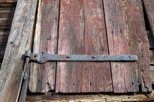 old shutter with rusty hinge in a barn