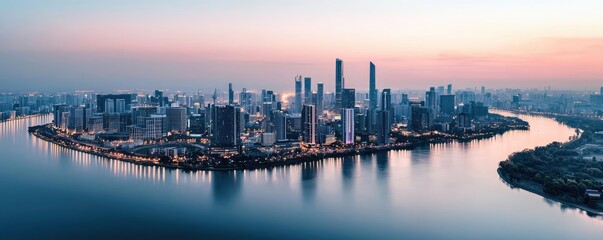 Fototapeta premium Panoramic city skyline at dusk with reflected lights on calm waters.