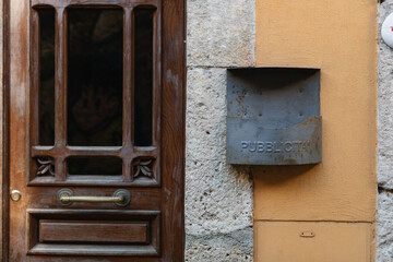 Mailbox near the front door on the wall of the house on a sunny day.