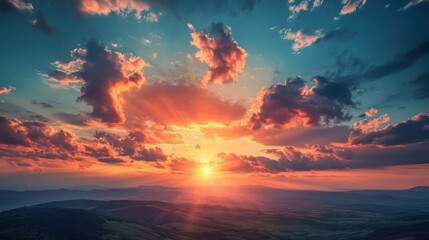 Fototapeta premium A dramatic sunset view above steep hills, with fluffy clouds